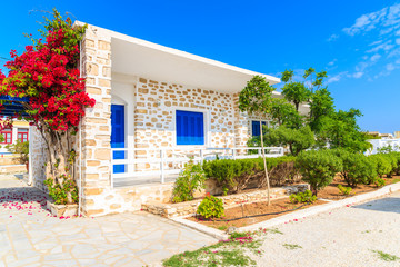 Fototapeta na wymiar Typical Greek house decorated with flowers in Naoussa town, Paros island, Greece