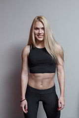 Portrait of a blonde woman wearing sports clothing in gym