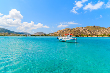 Typical Greek fishing boat sailing on turquouise sea water on Paros island, Greece - obrazy, fototapety, plakaty