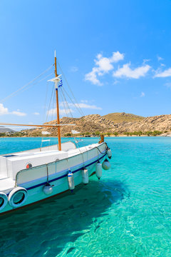 Bow of typical Greek fishing boat sailing on turquoise sea water on Paros island, Greece