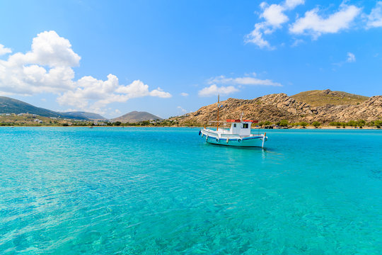 Typical Greek fishing boat sailing on turquouise sea water on Paros island, Greece