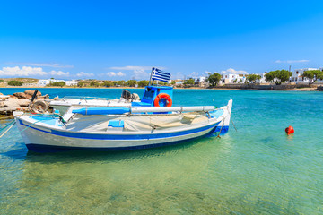 Fototapeta na wymiar Fishing boat in small sea bay in Naoussa town, Paros island, Greece