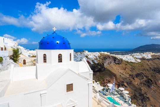 Blue dome of church in Imerovigli village and view of blue sea with caldera on Santorini island, Greece © pkazmierczak