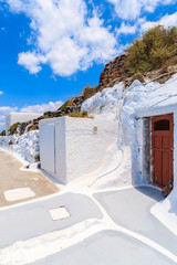 Narrow street in Oia village with typical white Greek architecture, Santorini island, Greece