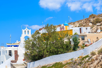View of colorful houses and church Oia village on Santorini island, Greece