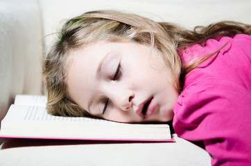 little girl asleep on the book