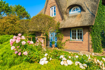 Typical Frisian house with straw roof in Kampen village on Sylt island, Germany