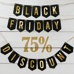 Black Friday seventy five percent Discount paper banner garland lettering hanging on white barn wood planks background. Luxurious square holiday flyer.