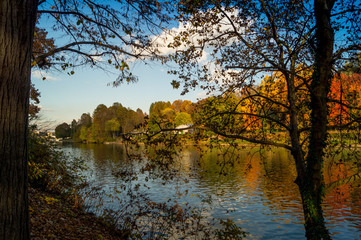 Colorfull italian park with trees and autumn colors and water