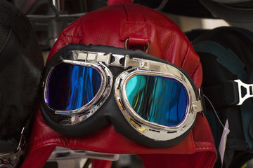 Red vintage leather motorcycle and aviator helmet hat with googles