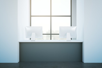 Obraz na płótnie Canvas Grey reception desk with computers