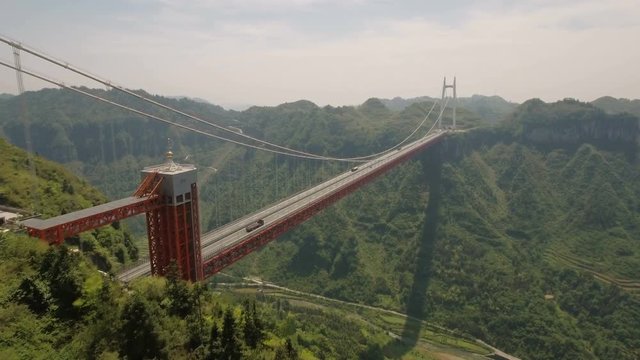 Stunning panoramic aerial view flying towards the Aizhai suspension bridge in China
