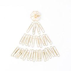 creative arrangement of bright golden christmas tree made of clips on white background. flat lay, top view