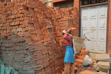 Fototapeta premium Woman working with bricks in Banepa, Nepal