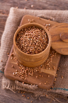 buckwheat groats on wooden surface © Diana Taliun