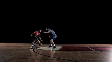 A basketball player dribbles past a defender and then dunks the ball - Powered by Adobe