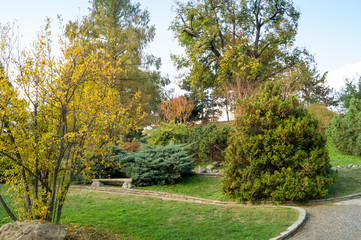 Fototapeta na wymiar Colorfull italian park with trees and autumn colors