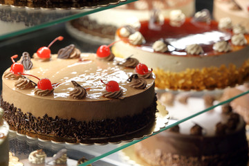 Different types of cakes in pastry shop glass display