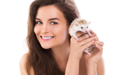 Happy and smiling woman and cute little hedgehog