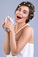 Beautiful woman is holding a cute little hedgehog