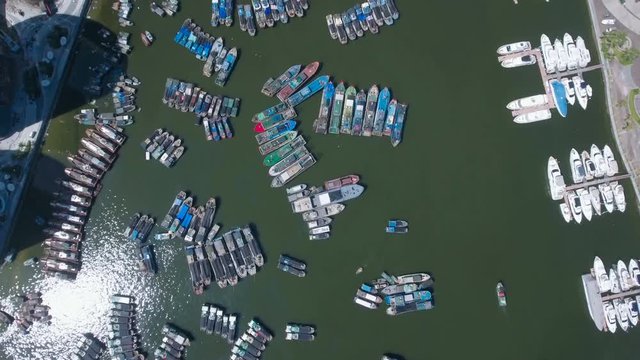 Chinese fishing fleet and modern apartment buildings aerial