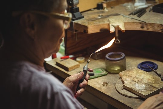 Craftswoman using blow torch