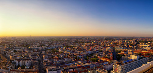 Obraz na płótnie Canvas Berlin. Germany - September 2016: Beautiful panoramic aerial view over northern Berlin with romantic colorful sunset and Tegel Airport in background.