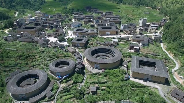 Aerial drone flight over tulou round houses in Fujian province China