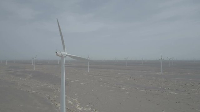 Static drone shot of a wind turbine on a large windfarm in the deserts of Gansu in China