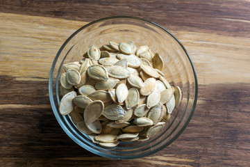Grilled Pumpkin seeds with sea salt and spices on the wooden background