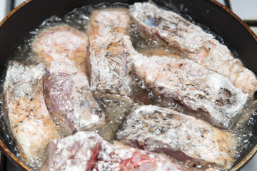 fish is fried in a pan