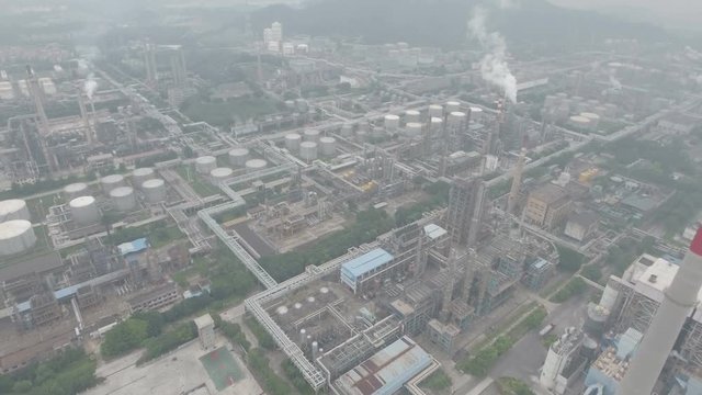 Aerial overview of an oil refinery, heavy industry and polluting smokestacks in Guangzhou, China