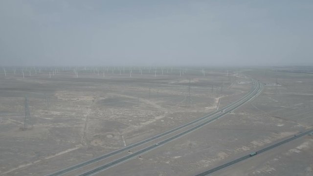 High angle aerial view of a major highway and massive windfarm in the Gansu deserts in central China
