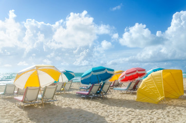 Colorful Beach umbrellas/parasols and cabanas near ocean