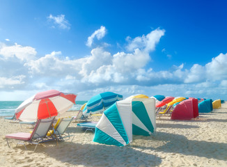 Colorful Beach umbrellas/parasols and cabanas near ocean