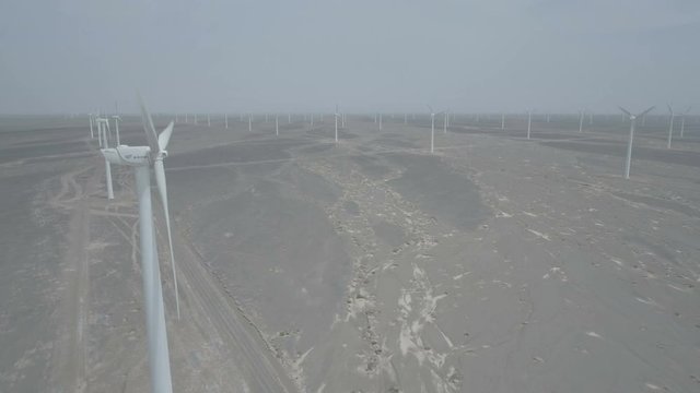 Static drone shot of a wind turbine on a large windfarm in the deserts of Gansu in China
