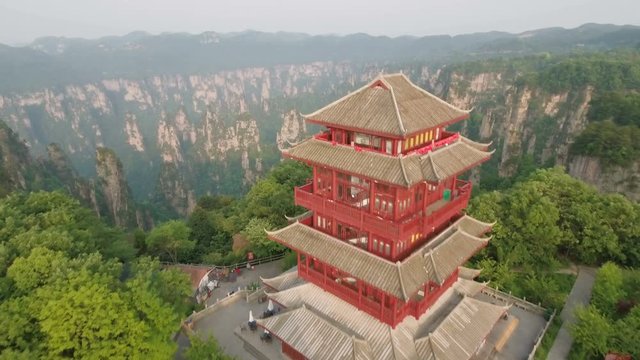 Aerial of red pagoda building reveals mountain panorama in Zhangjiajie China