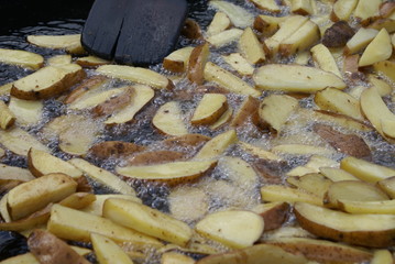 Young potatoes fried in boiling oil to a frying pan