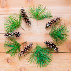 Pine cones and branches in form of Christmas wreath on  wooden t