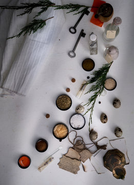 jars of powders, leaves burnt paper, scales on the table. top view