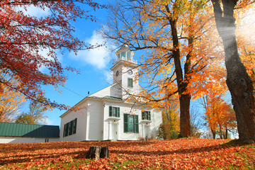 Small church in typical New England town with fall foliage