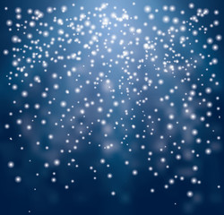 White transparent Falling Christmas sparks on blue background.