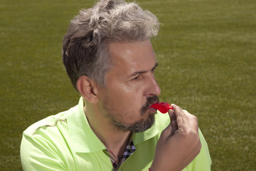 Soccer concept - man referee whistling pointing