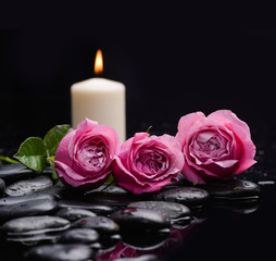 Fototapeta na wymiar Still life with three rose with candle and therapy stones 