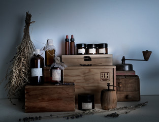 alchemy lab. bottles, jars, dried wormwood bouquet on wooden shelves