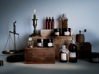 old pharmacy. bottles, jars, scales, candle on wooden shelves