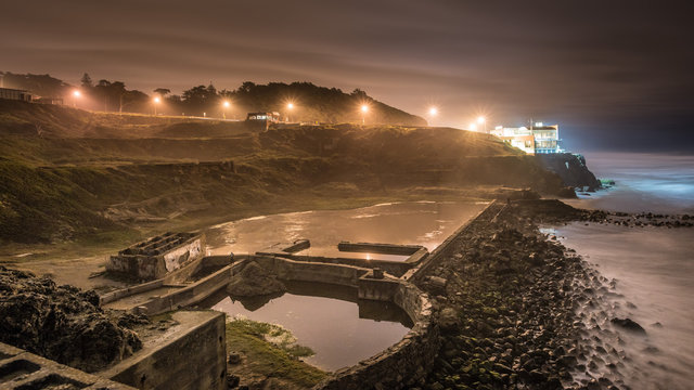 Sutro Baths Ruins with a Distant House in San Francisco at Night