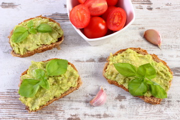 Freshly sandwiches with paste of avocado and ingredients, healthy food and nutrition