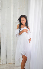 Fototapeta premium Nude woman covered herself with a white sheet. 