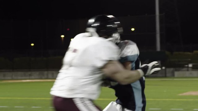 A football player runs with ball avoids tackles and then scores a touchdown